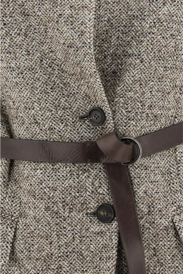Close-up of a textured coat with a brown belt and buttons.