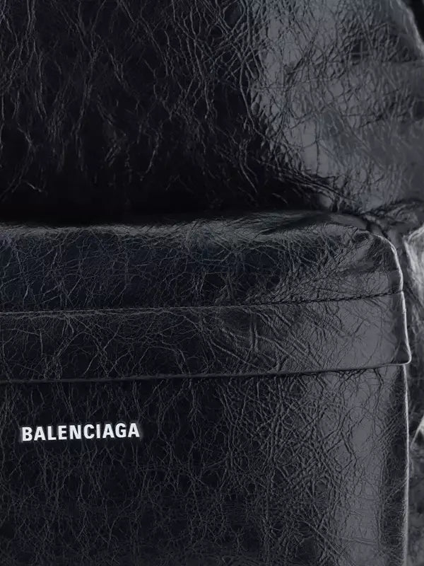 Close-up of a black textured bag with 'Balenciaga' logo.