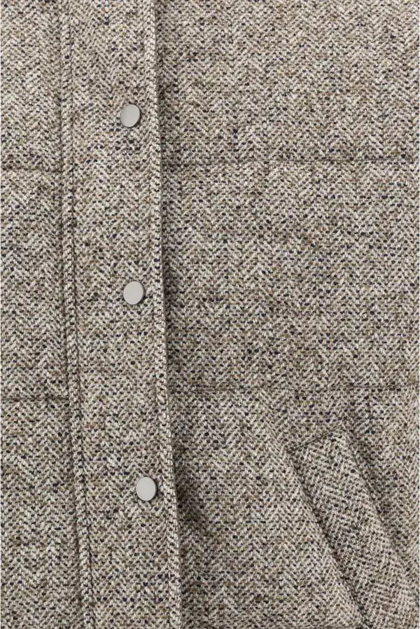 Close-up of a textured fabric with buttons on a garment