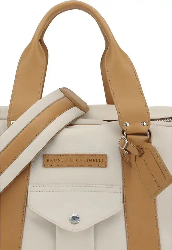 White handbag with tan straps and Brunello Cucinelli logo on a white background