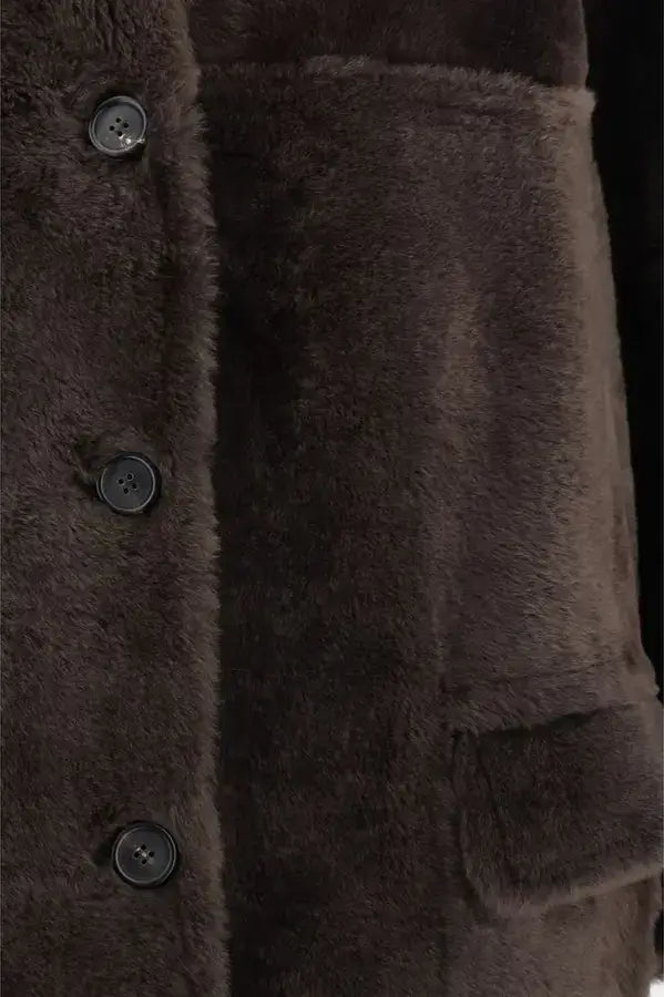 Close-up of a brown textured coat with buttons