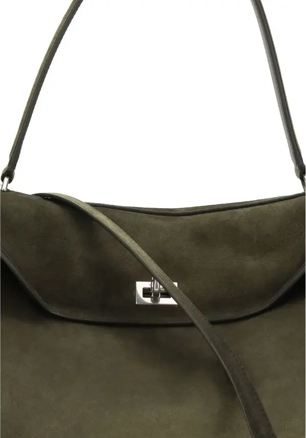 Green suede handbag with a visible brand logo on a light gray background