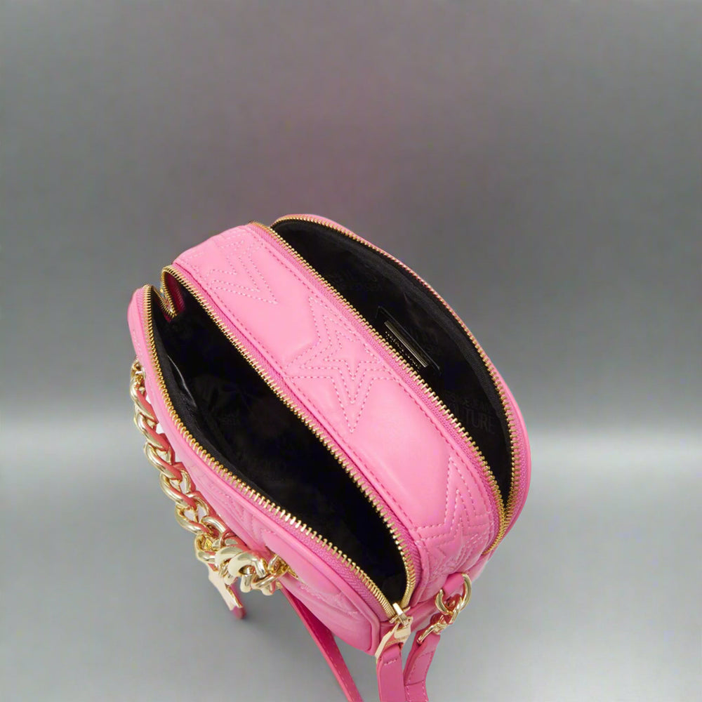 Versace Jeans Couture crossbody bag in pink with gold emblem, featuring two zippered compartments and chain strap.