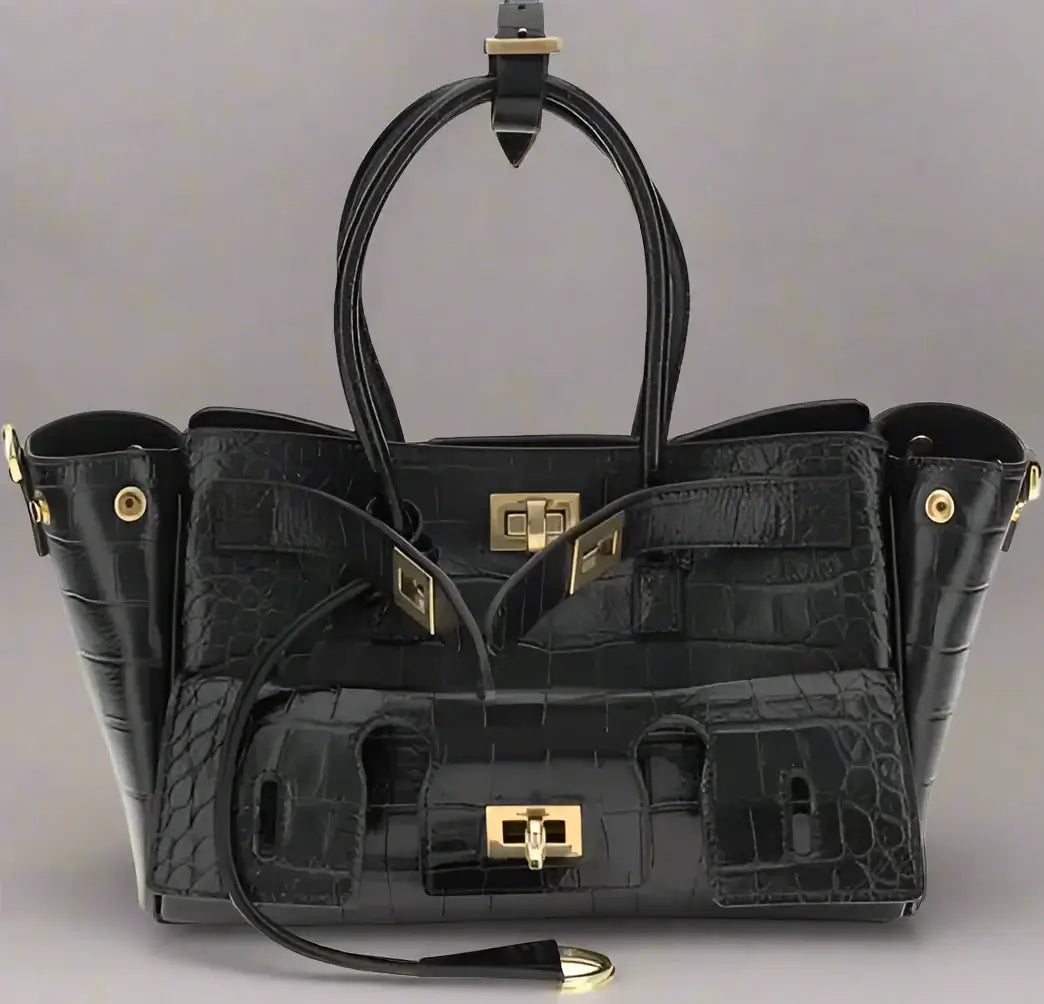 Black crocodile-patterned handbag with gold hardware on a white background