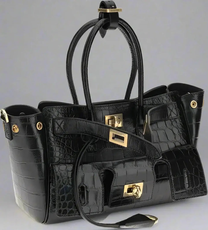 Black crocodile-patterned handbag with gold hardware on a white background