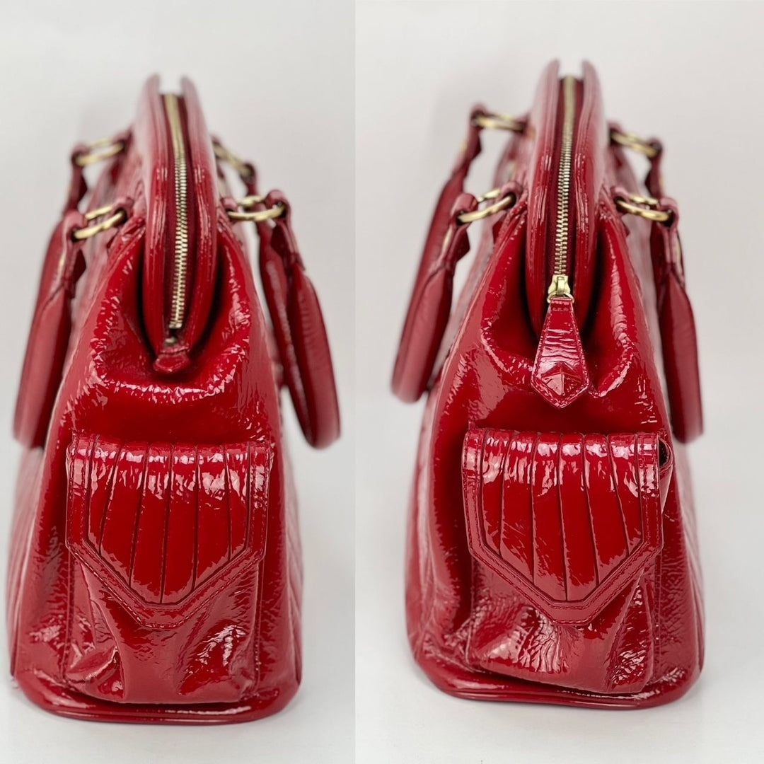Isabella Fiore Red Patent Leather Hand bag side view showcasing its luxury design and patent leather material.