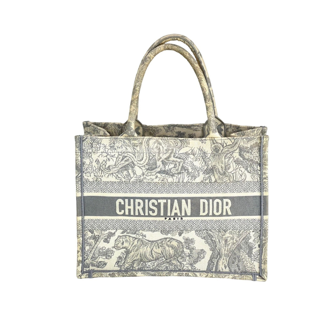 Christian Dior handbag with patterned design on a white background