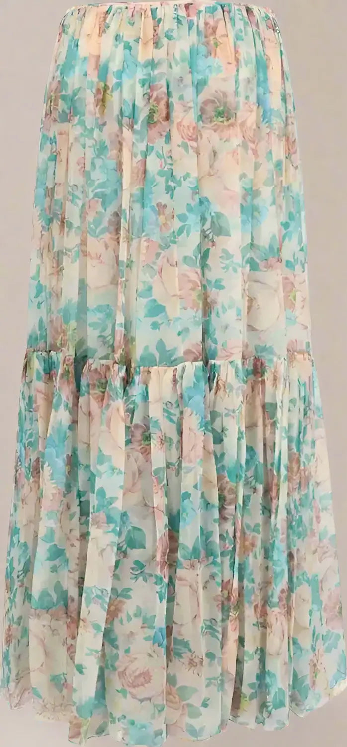 Floral print dress with a tiered design on a plain background