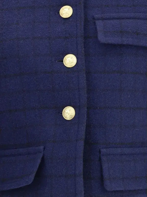 Close-up of a blue coat with gold buttons