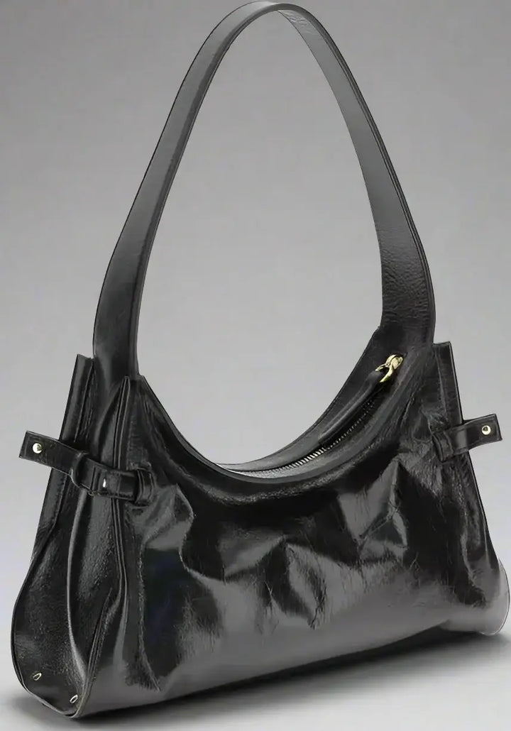 Black handbag with a strap on a white background
