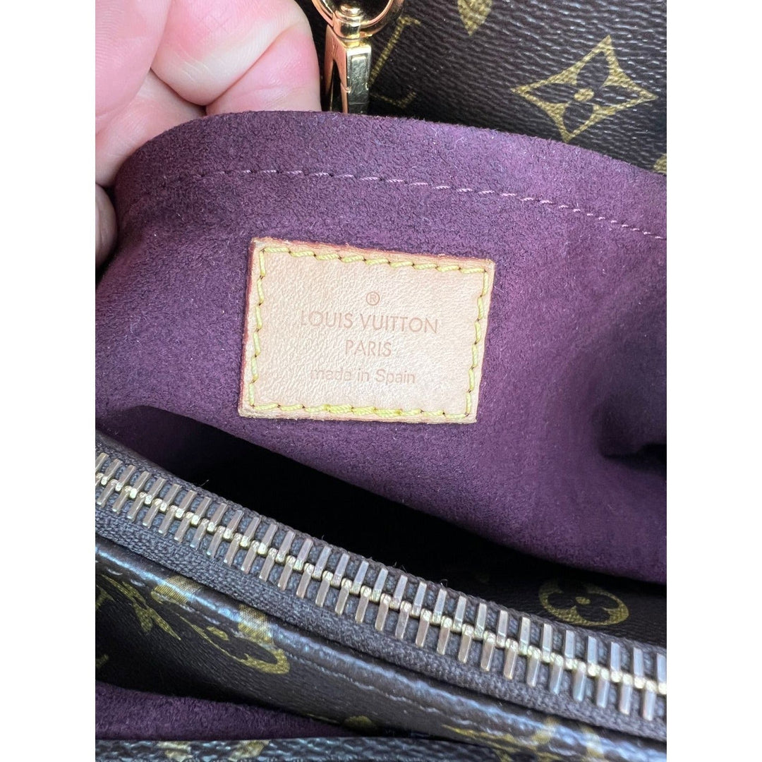 Close-up of a Louis Vuitton bag with a visible label.