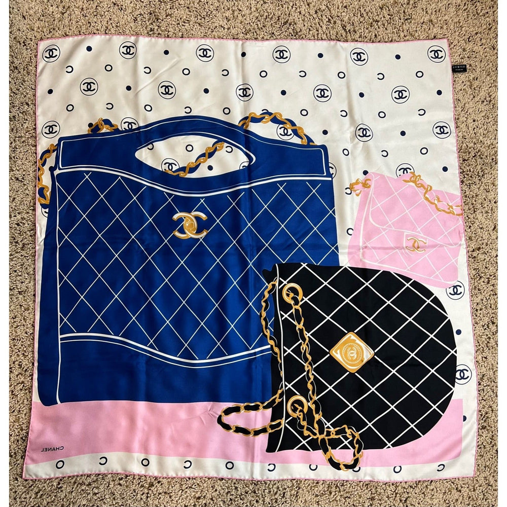 Chanel-themed scarf with blue and black handbag designs on a white background with black polka dots.