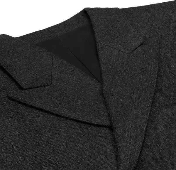 Close-up of a dark gray coat with a collar and lapel on a white background