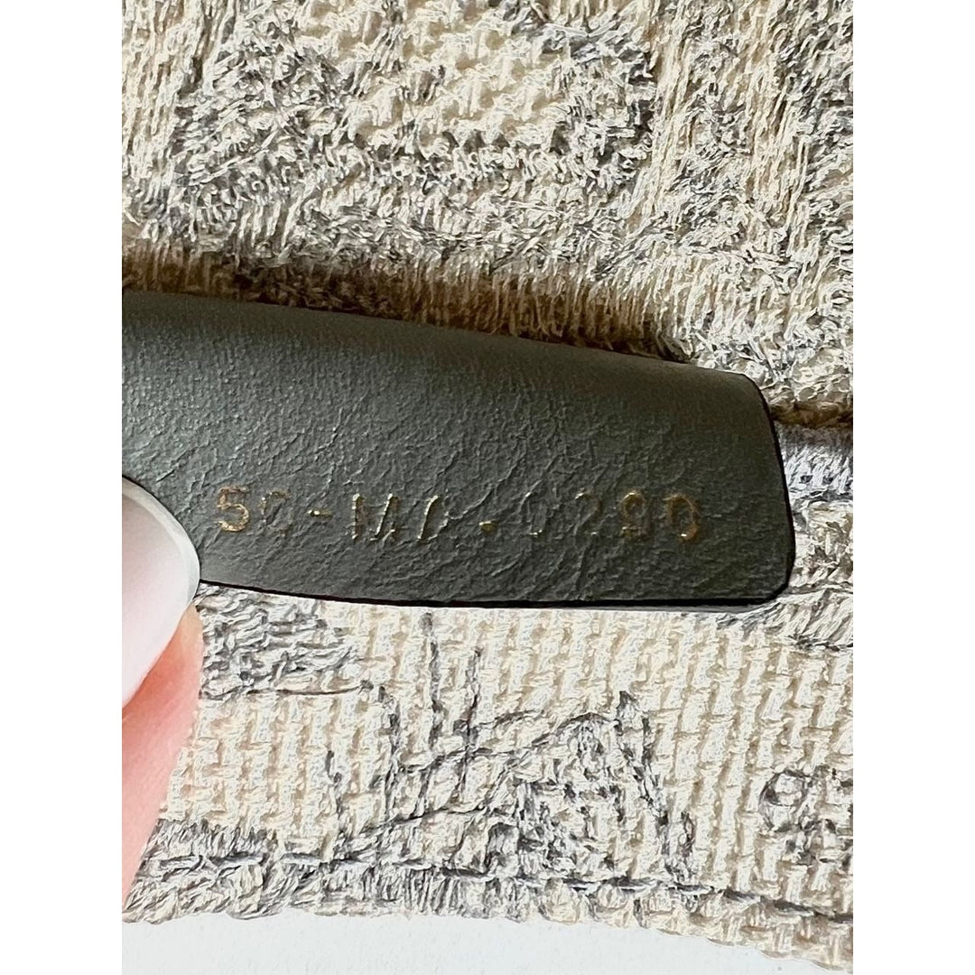 Close-up of textured fabric with a leather tag displaying a code.