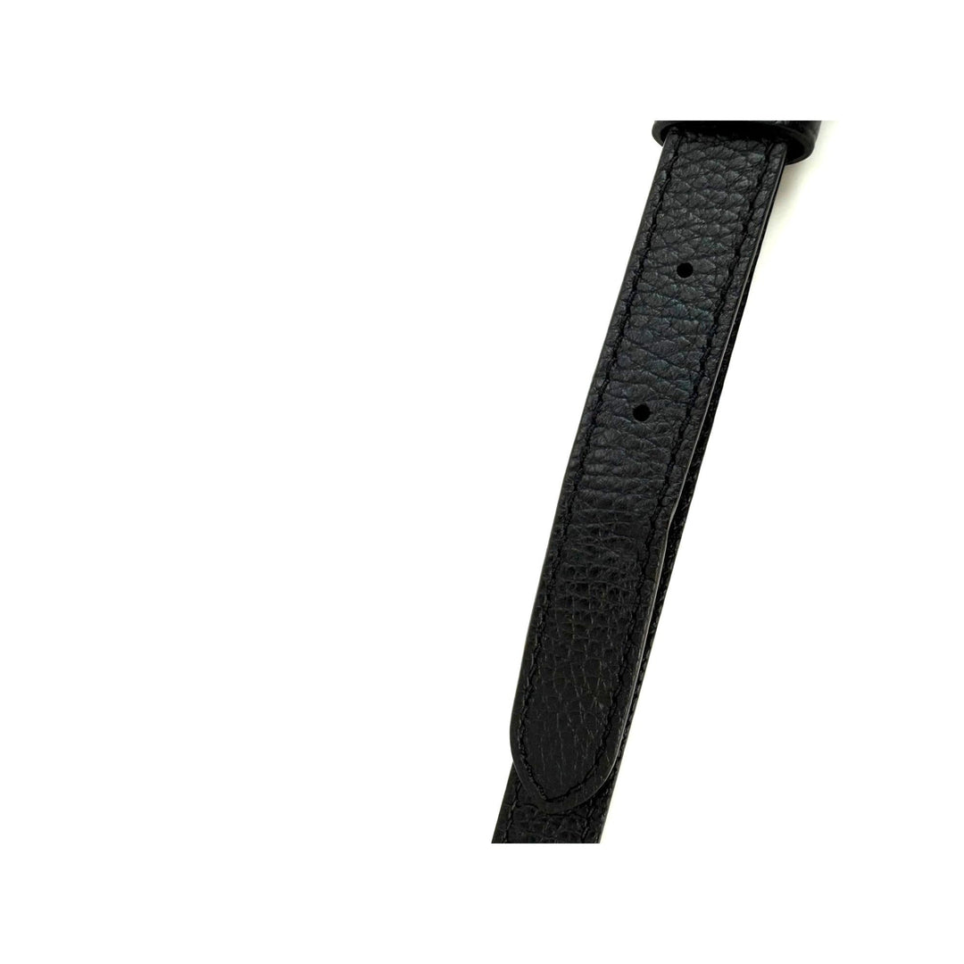 Black leather watch strap on a white background