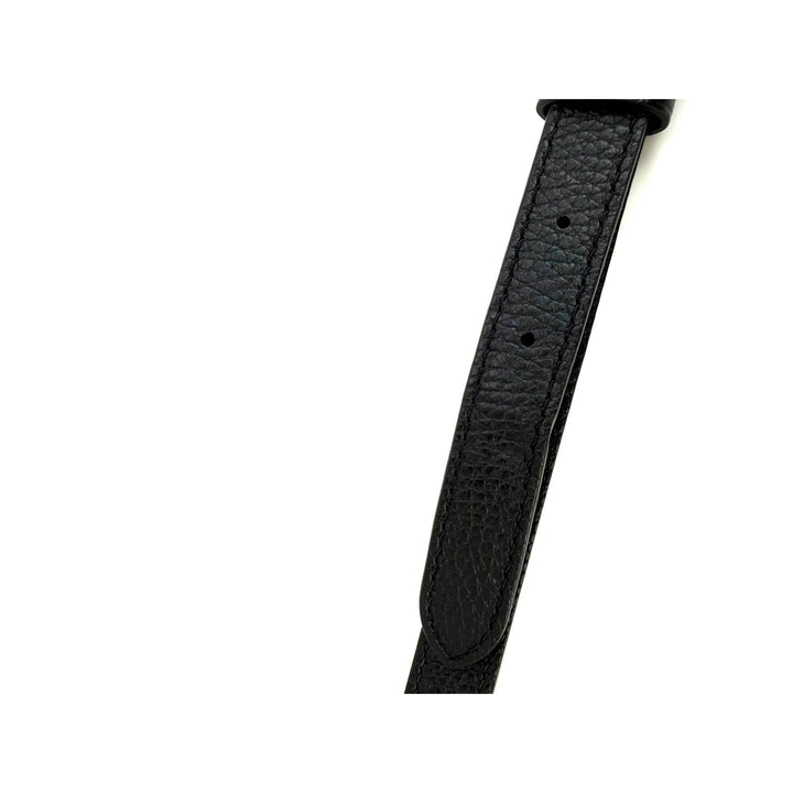 Black leather watch strap on a white background