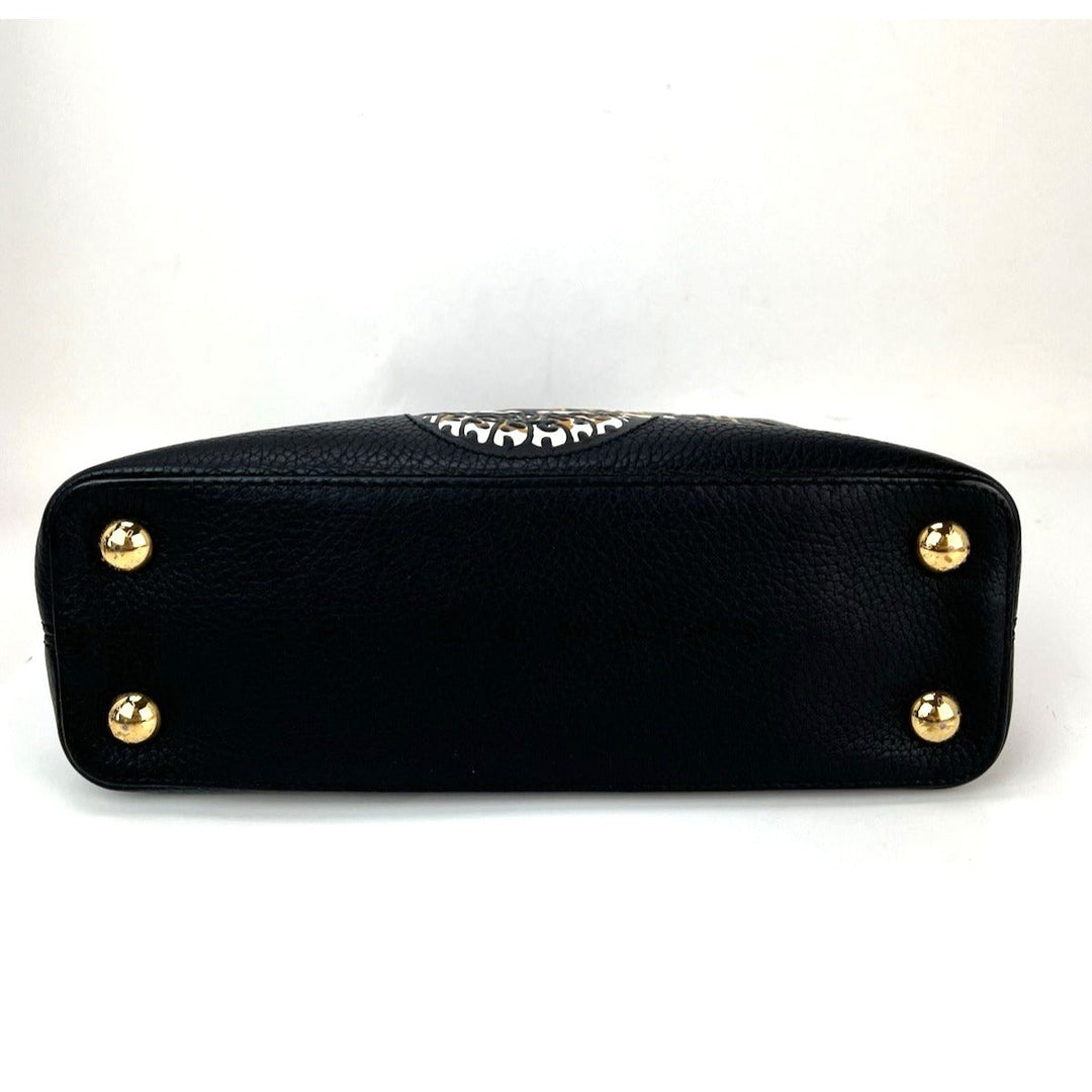 Black handbag with gold studs on a white background