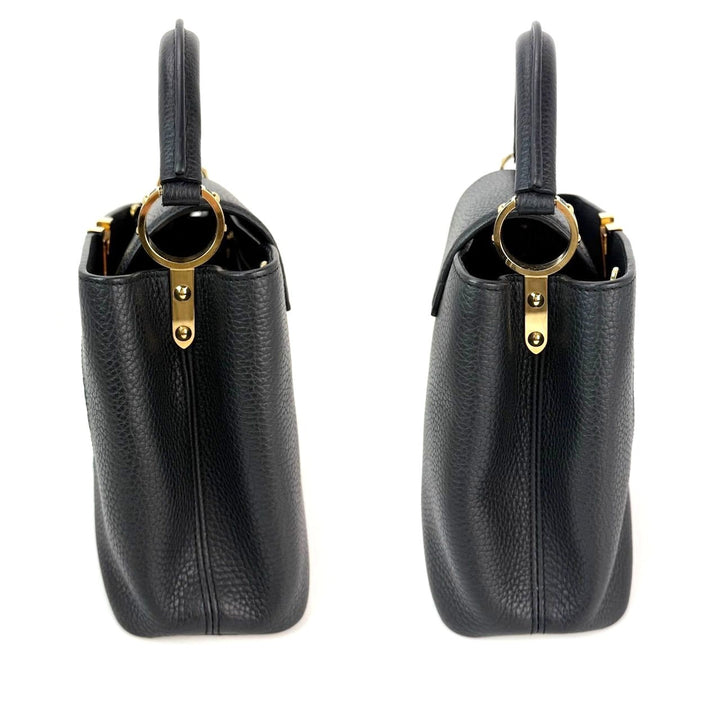 Two black handbags with gold accents on a white background