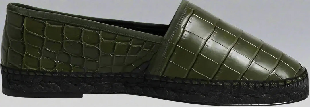 Green slip-on shoe with textured surface on a white background