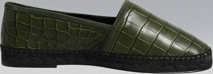 Green slip-on shoe with textured surface on a white background