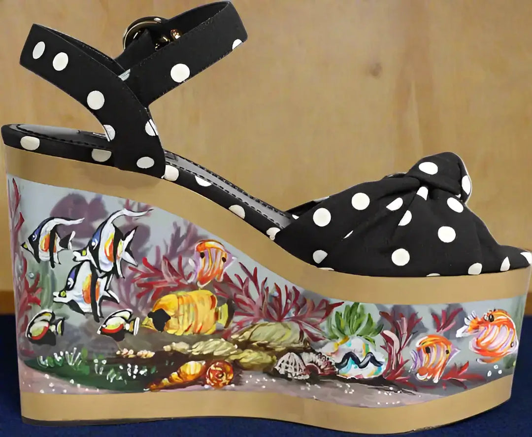 Black polka dot wedge sandal with a colorful underwater scene design on the sole.