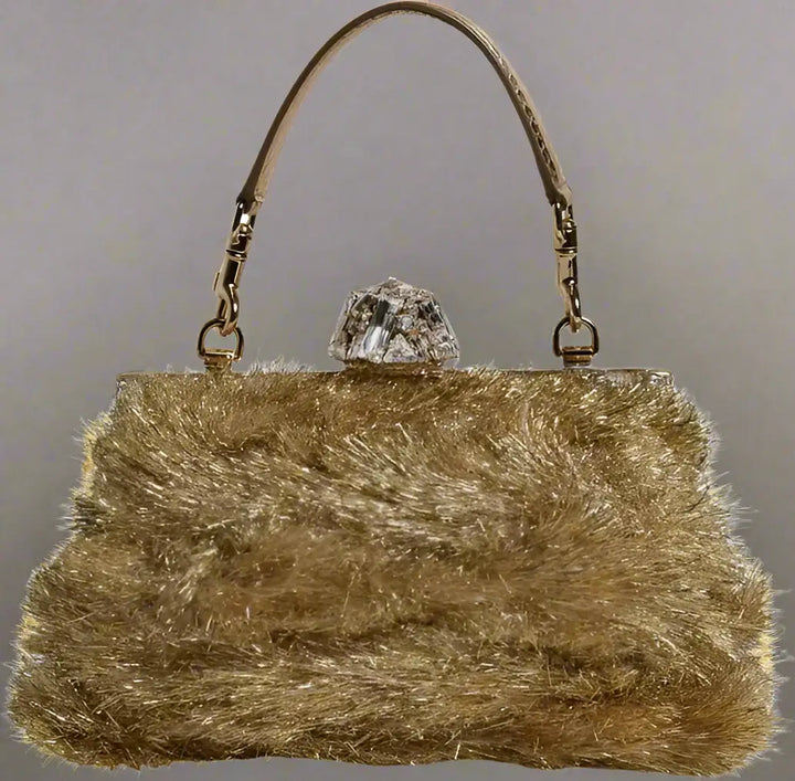 Gold fluffy handbag with a crystal clasp on a white background