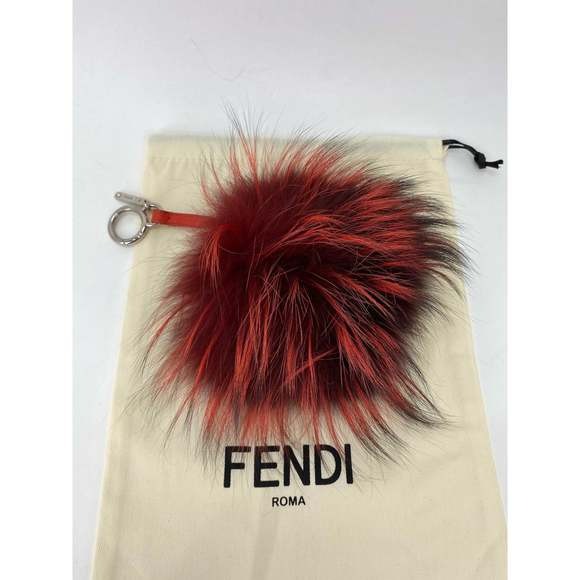 Fendi fluffy keychain with red and black fur on a branded pouch