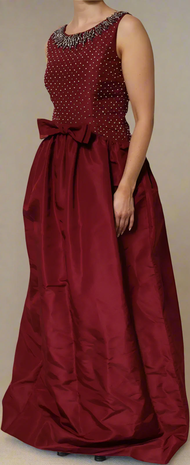 Red evening gown with beaded top on a white background