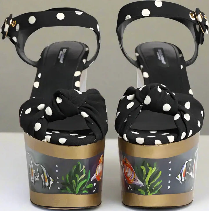 Black polka dot sandals with goldfish design on the sole
