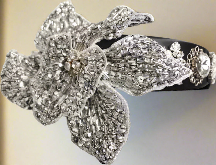 Decorative hair clip with floral design and rhinestones on a white background