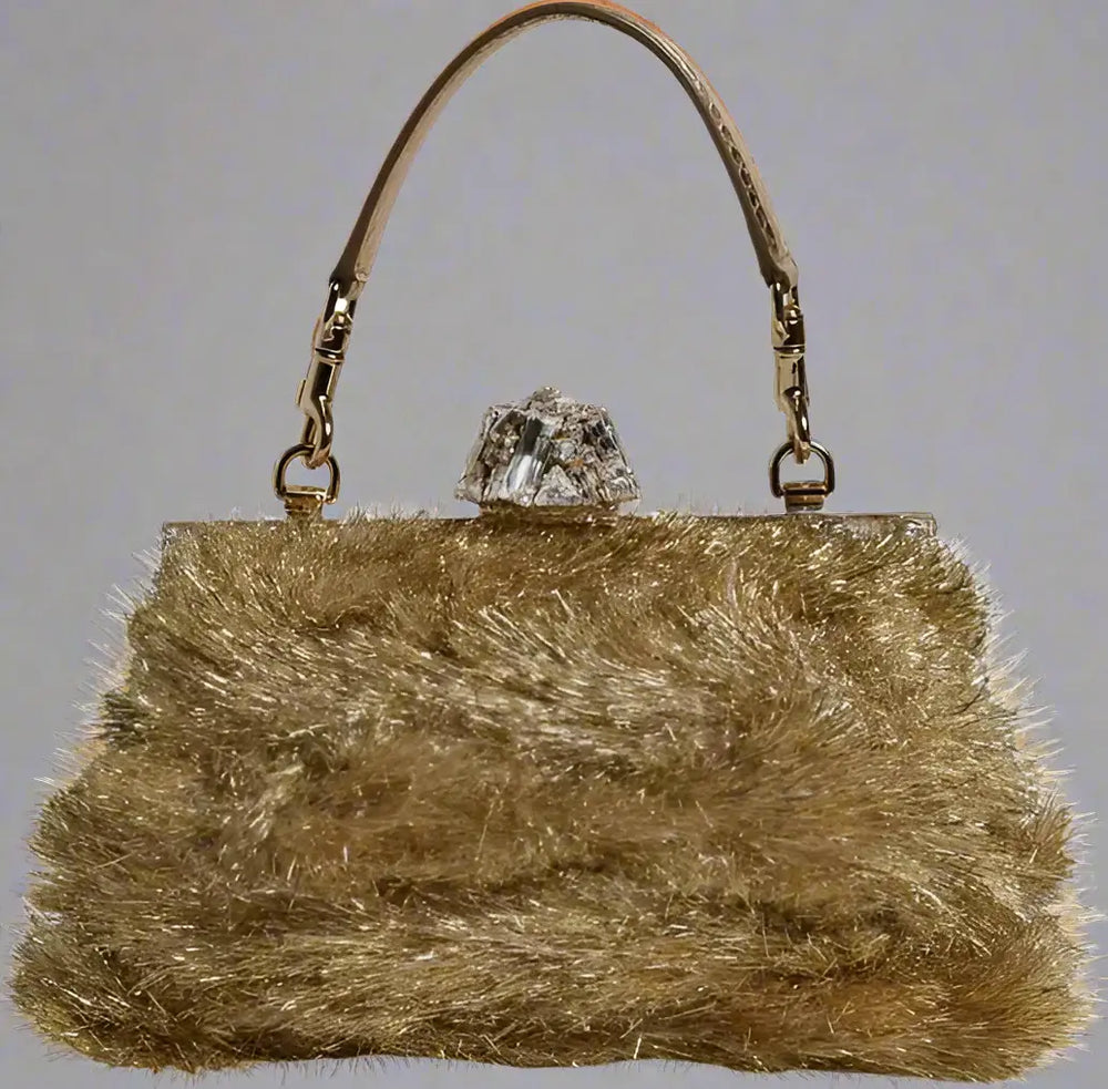 Gold fluffy handbag with a crystal clasp on a white background
