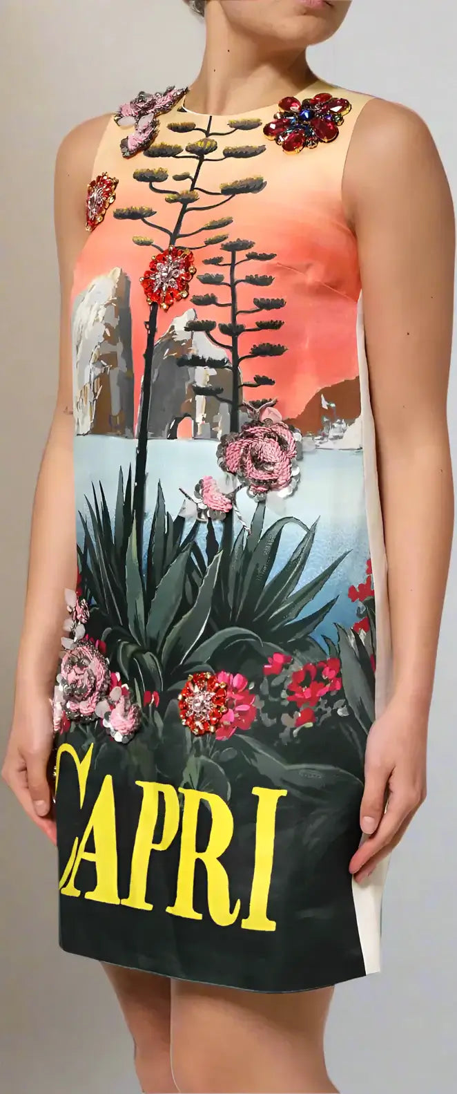Dress with floral design and 'Capri' text worn by a person