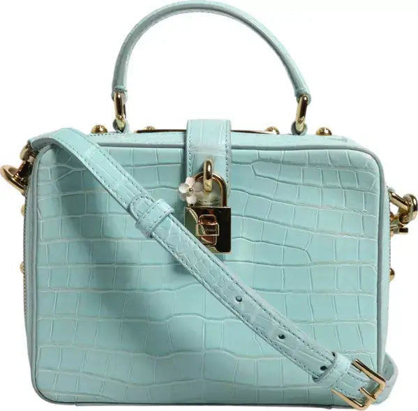 Light blue handbag with gold accents on a white background