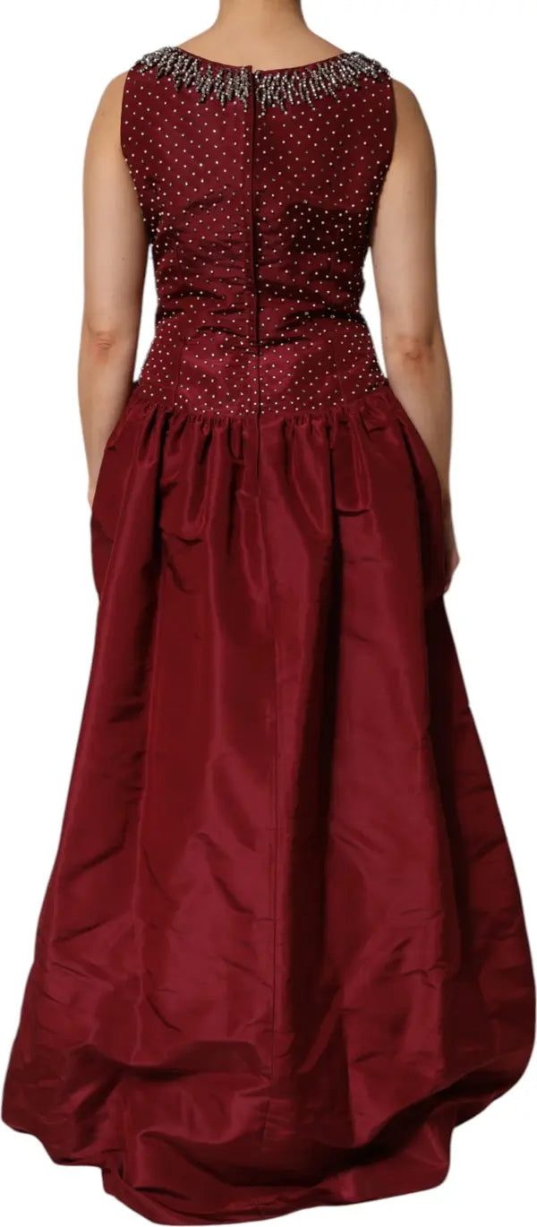 Red evening gown with intricate top design on a white background