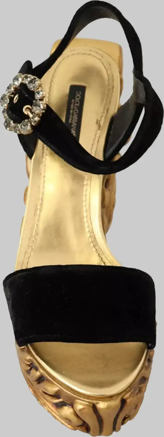 Gold sandal with black straps and decorative buckle on a white background