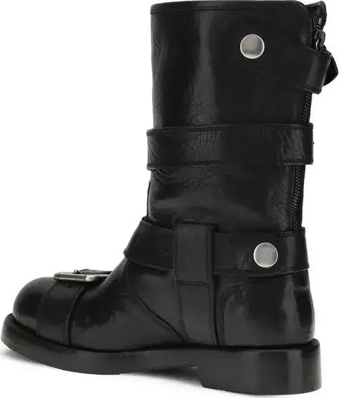 Black leather boot with multiple straps and buckles on a white background