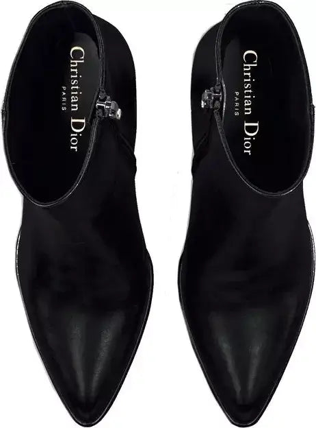 Black Christian Dior shoes on a white background