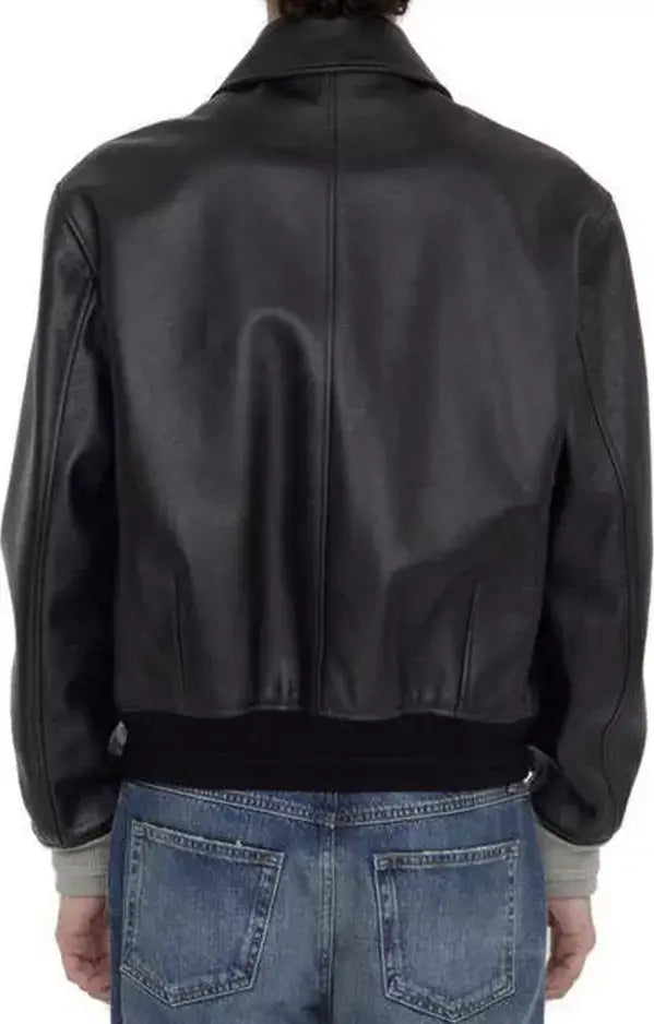 Black leather jacket worn by a person on a white background