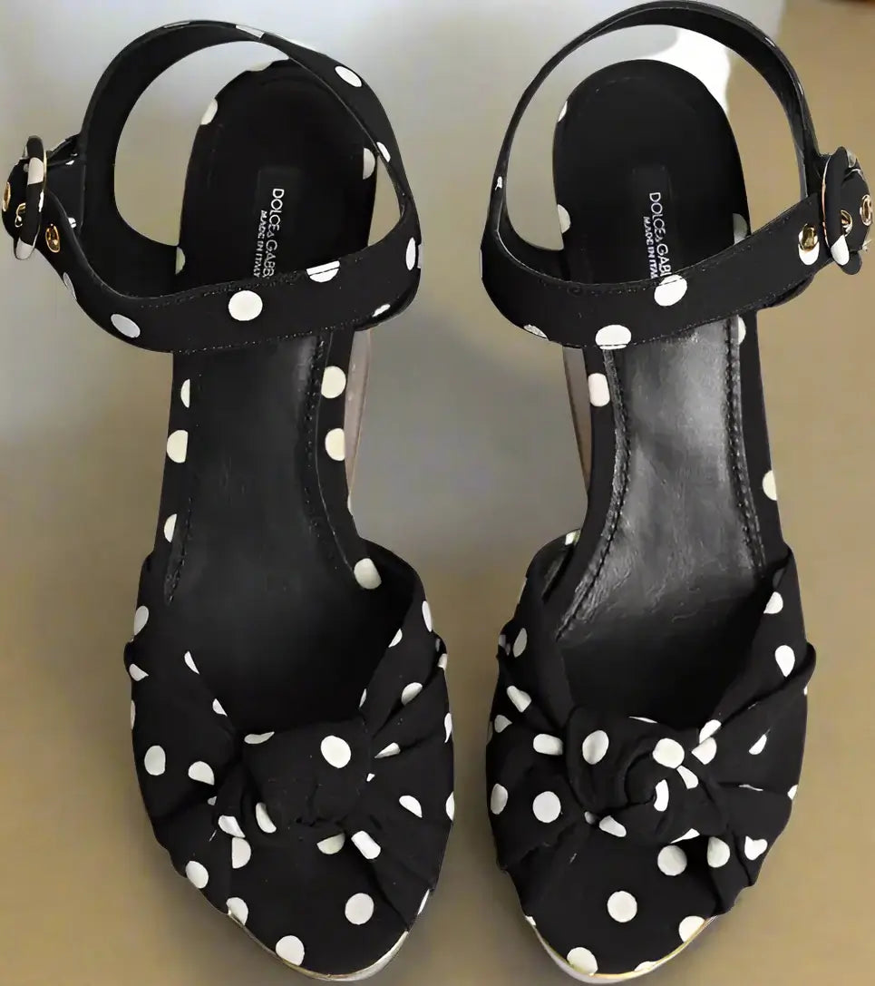 Black sandals with white polka dots on a white background