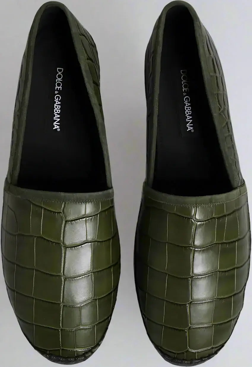 Green loafers with crocodile pattern on a white background