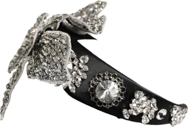 Decorative black shoe with silver embellishments on a white background