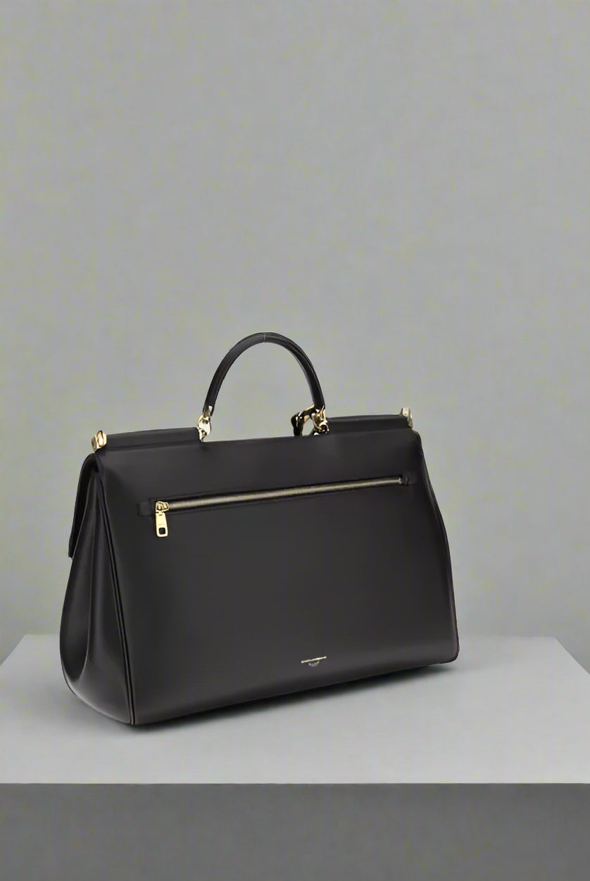 Black handbag with gold zipper on a white background