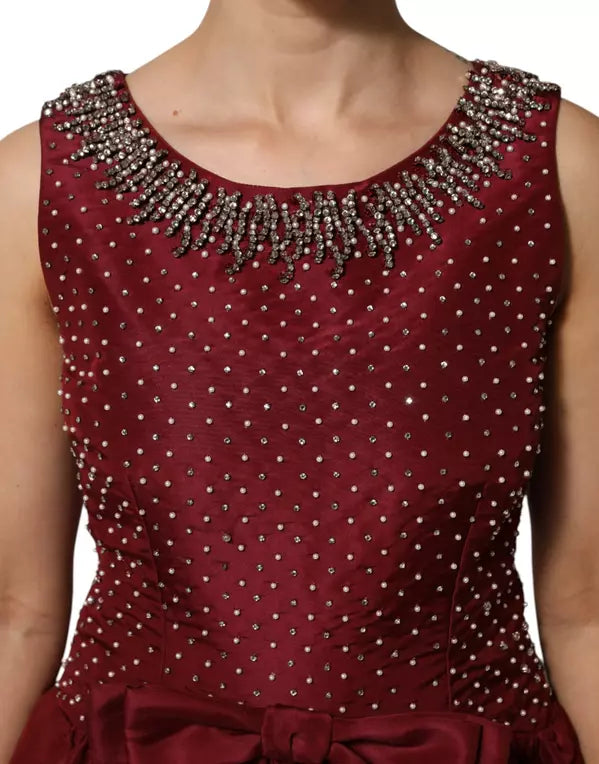 Maroon dress with bead embellishments on a white background