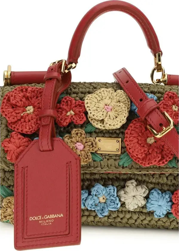 Dolce & Gabbana handbag with floral patterns and a matching red tag on a white background
