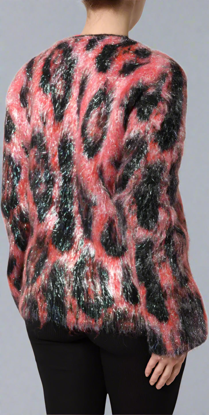 Person wearing a colorful, patterned sweater on a white background