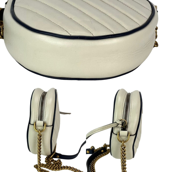 White handbag with gold chain strap on a white background