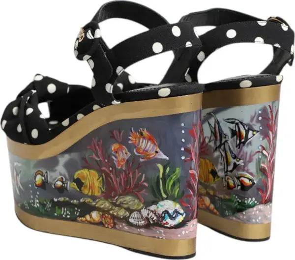Black polka dot sandals with transparent platforms featuring fish and coral designs.