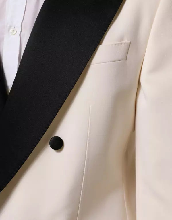 Close-up of a beige blazer with a black lapel and button.