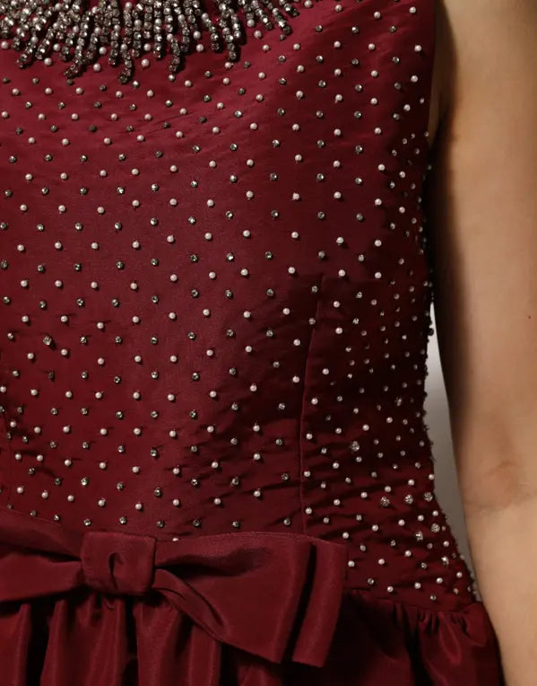 Maroon dress with bead embellishments and a bow detail