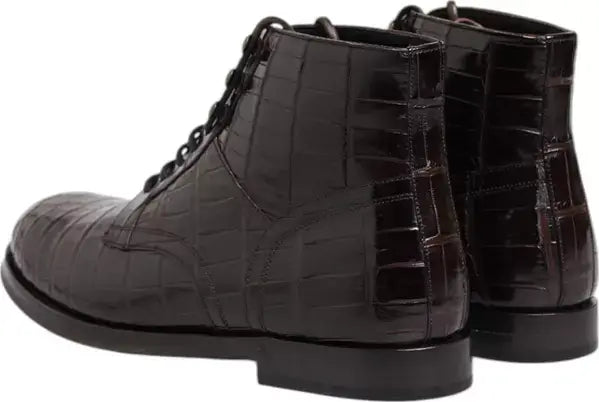 Pair of black crocodile-patterned leather boots on a white background